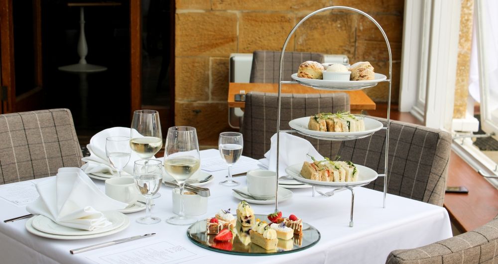 Table set with snacks, tea and wine